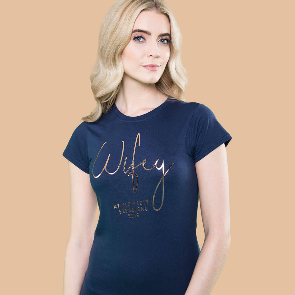 About Mr Porkys female model wearing Wifey hen party t shirt in navy with gold foil print