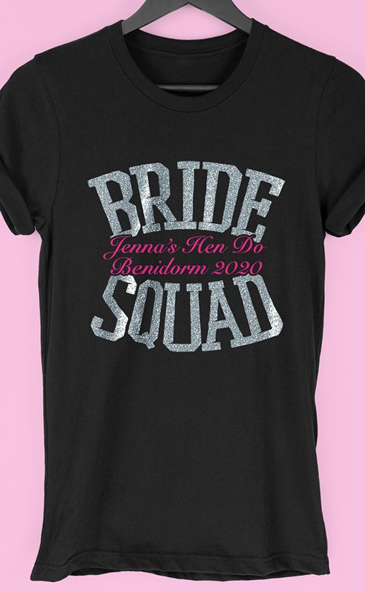 Image to buy product Bride Squad Glitter Personalised Hen Party T Shirt. Bold lettering in glitter silver print with subtext in fuchsia on a black t-shirt.