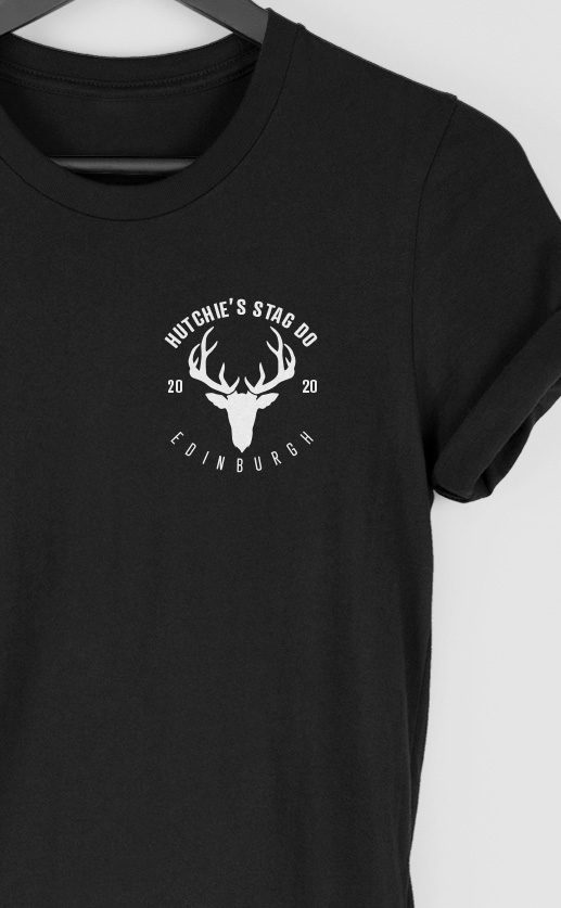 Small top left graphic of a stag silhouette with horns. Personalised text around and under design. White print on black t-shirt.